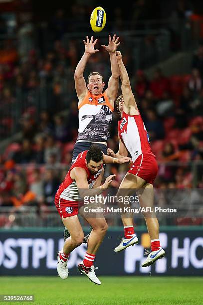 Steve Johnson of the Giants is challenged by Heath Grundy and Dane Rampe of the Swans during the round 12 AFL match between the Greater Western...