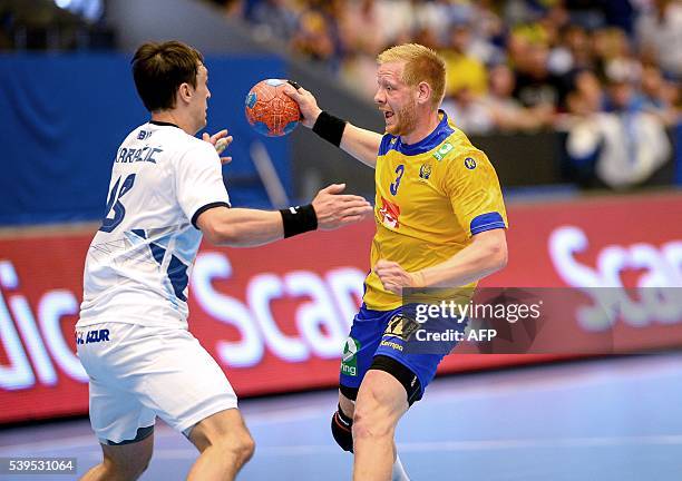 Bosnia's Ivan Karacic and Sweden's Jim Gottfridsson vie for the ball during the men's World Championship handball qualification match between Sweden...