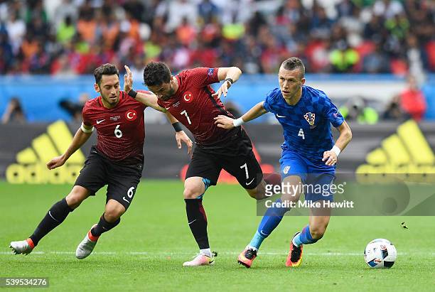 Ivan Perisic of Croatia competes for the ball against Hakan Calhanoglu and Hakan Calhanoglu of Turkey during the UEFA EURO 2016 Group D match between...