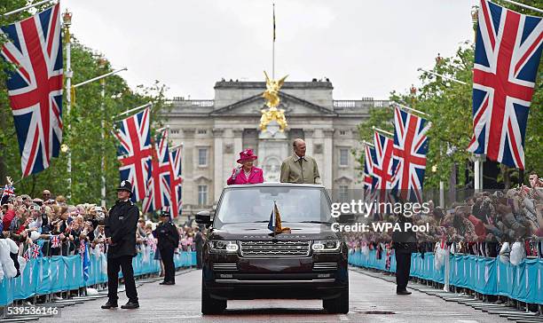 Queen Elizabeth II and Prince Philip, Duke of Edinburgh wave to guests attending "The Patron's Lunch" celebrations for The Queen's 90th birthday on...