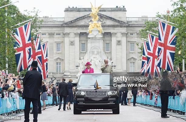Queen Elizabeth II and Prince Philip, Duke of Edinburgh wave to guests attending "The Patron's Lunch" celebrations for The Queen's 90th birthday on...