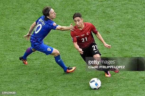 Croatia's midfielder Luka Modric vies for the ball against Turkey's forward Emre Mor during the Euro 2016 group D football match between Turkey and...