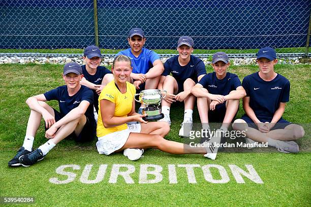 Marina Melnikova of Russia poses with the trophy and the ballkids after winning her Women's Final match against Stephanie Foretz of France during day...