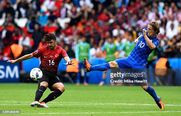 Ozan Tufan of Turkey and Luka Modric of Croatia compete for the ball during the UEFA EURO 2016 Group D match between Turkey and Croatia at Parc des...
