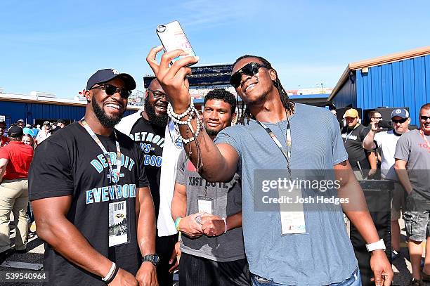 Players Antwione Williams; A'Shawn Robinson, Ian Wells, and Ezekiel 'Ziggy' Ansah of the Detroit Lions tour the garage area before the NASCAR Sprint...