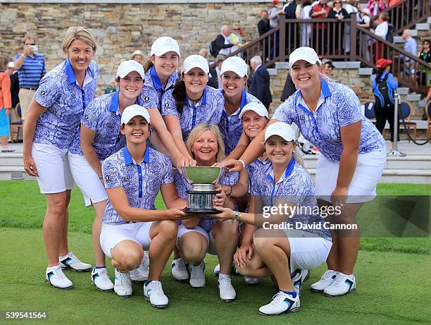 The Great Britain and Ireland team celebrate with the Curtis Cup trophy after they had secured a match total 11.5 to 8.5 victory in the final day's...