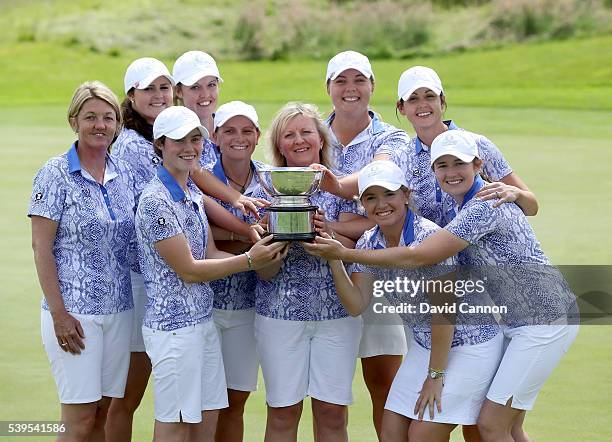 The Great Britain and Ireland team celebrate with the Curtis Cup trophy after they had secured a match total 11.5 to 8.5 victory in the final day's...