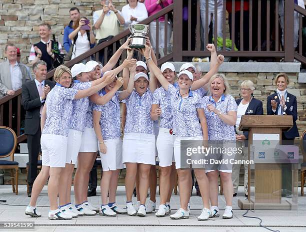 The Great Britain and Ireland team celebrate with the Curtis Cup trophy after they had secured a match total 11.5 to 8.5 victory in the final day's...