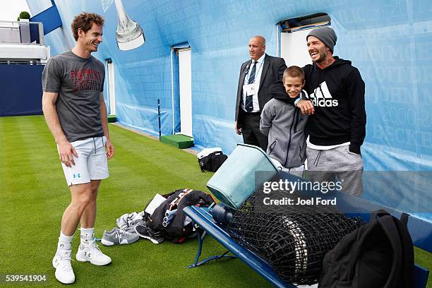 Andy Murray speaks with David Beckham and his son Romeo after the boy hit a few balls with Murray prior to a practice session at the Aegon...