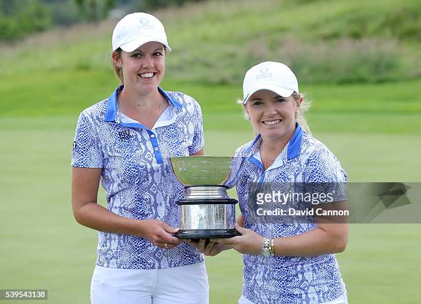 Bronte Law and Meghan MacLaren of England and the Great Britain and Ireland team celebrate with the trophy after their singles match wins had helped...