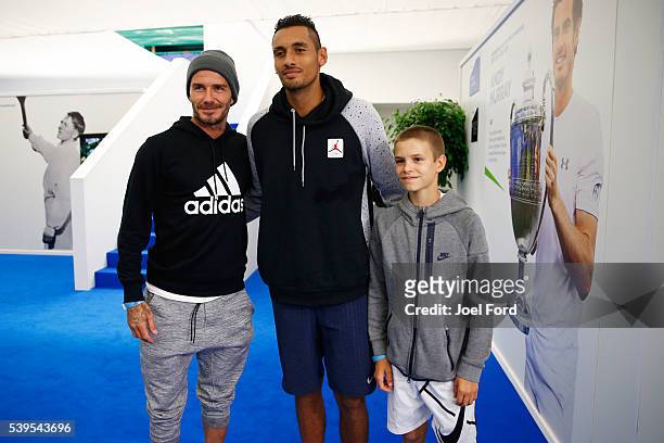 Former footballer David Beckham and his son Romeo pose for a picture with tennis player Nick Kyrgios at the Aegon Championships at Queens Club on...