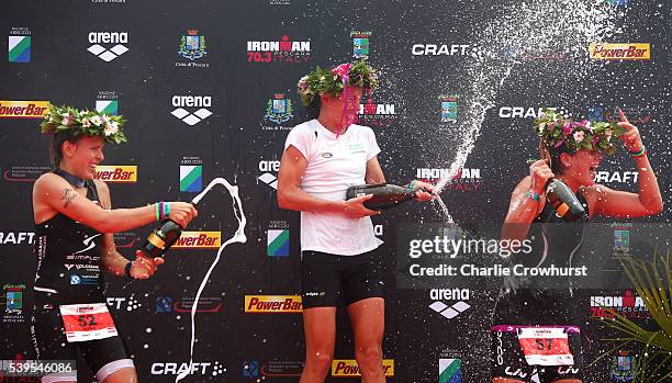 Blanca Steurer of Switzerland in second, Nicola Spirig of Switzerland in first and Camille Donat of France celebrate their placings winning the...