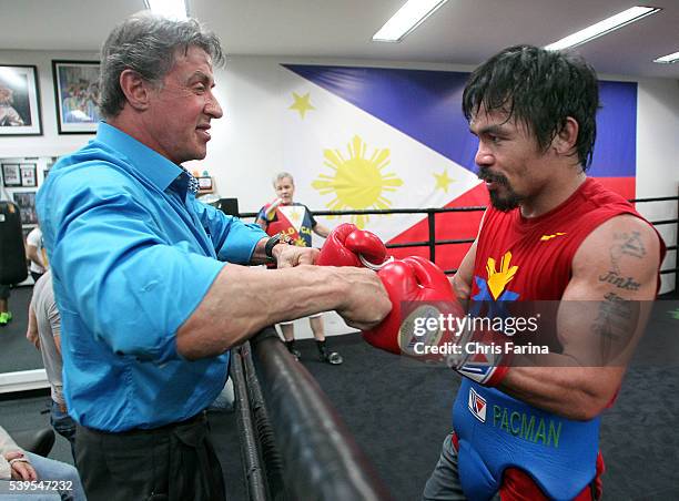 April 18 Hollywood,Calif. --- Actor Sylvester Stallone visits with boxer Manny Pacquiao and trainer Freddie Roach, Saturday at the Wild Card Boxing...