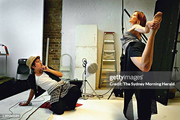 Vietnamese-Australian fashion designer Alistair Trung, left, admires model, Felicity King, as she poses at Adam Taylor Photography Studio during a...