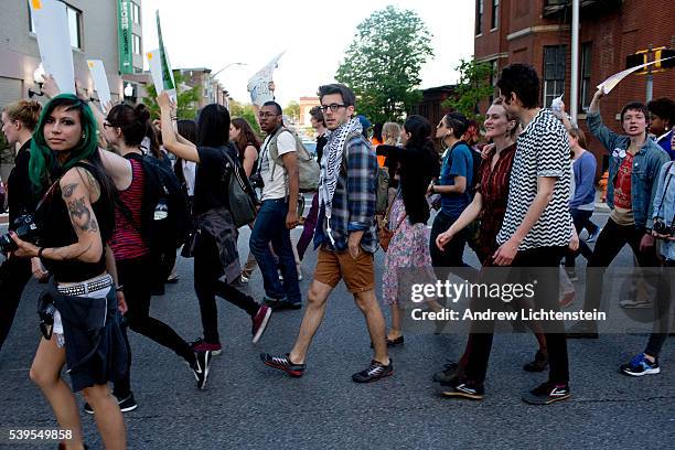 Baltimore residents watch a demonstration of students march through the city to protest the killing of Freddie Gray while in police custody.