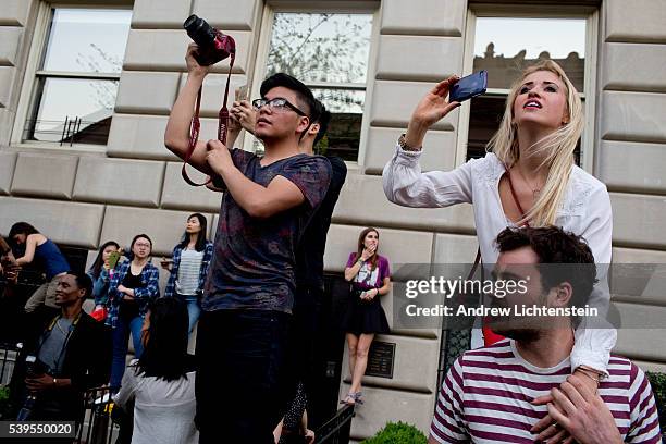 Large crowds form across the street from the Metropolitan Museum on Manhattan's Upper East Side to watch, cheer, and photograph the rich and famous...