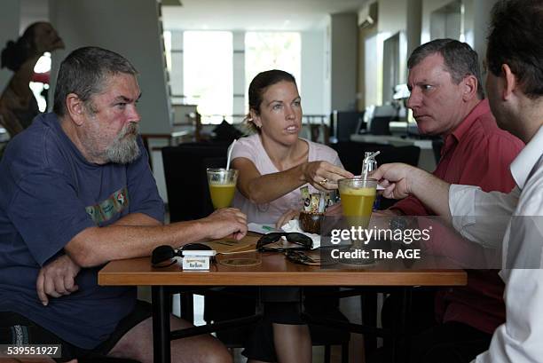 From left, Michael Corby and his daughter Mercedes Corby meet with Australian QC Mark Trowell and his associate Phillip Laskaris, partly obscured, in...