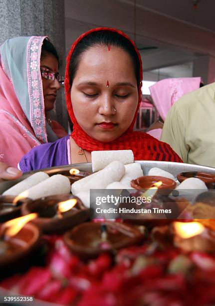 Kashmiri migrant devotees offer prayers during the annual Hindu festival at the Kheer Bhawani Temple, on June 12 in Jammu, India. Around 13,000...