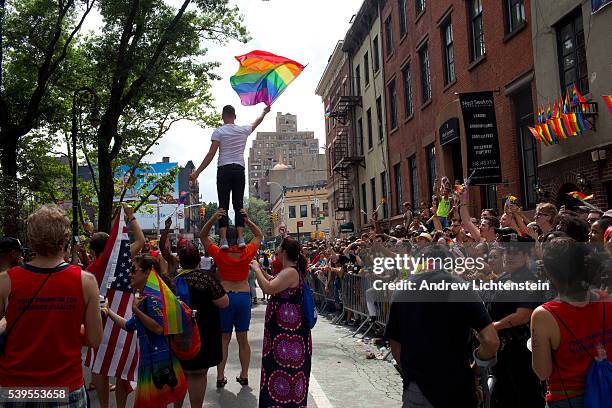 Huge crowds gather on Christopher Street in the West Village, outside of the historic Stonewall Inn, to watch and march in the annual New York Gay...