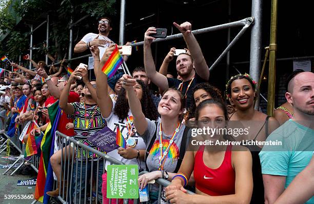 Huge crowds gather on Christopher Street in the West Village, outside of the historic Stonewall Inn, to watch and march in the annual New York Gay...