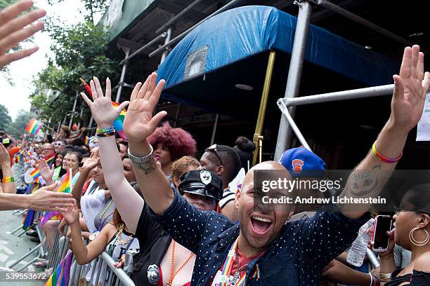 Huge crowds gather on Christopher Street in the West Village, outside of the historic Stonewall Inn, to watch and march in the annual New York Gay...