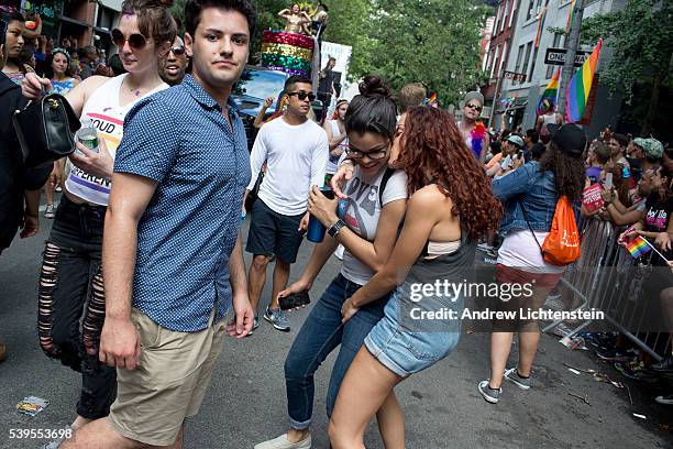 Huge crowds gather on Christopher Street in the West Village, outside of the historic Stonewall Inn, to watch and march in the annual New York Gay...