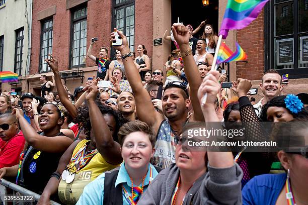 Huge crowds gather on Christopher Street in the West Village, outside of the historic Stonewall Inn, to watch and march in the annual New York Gay...