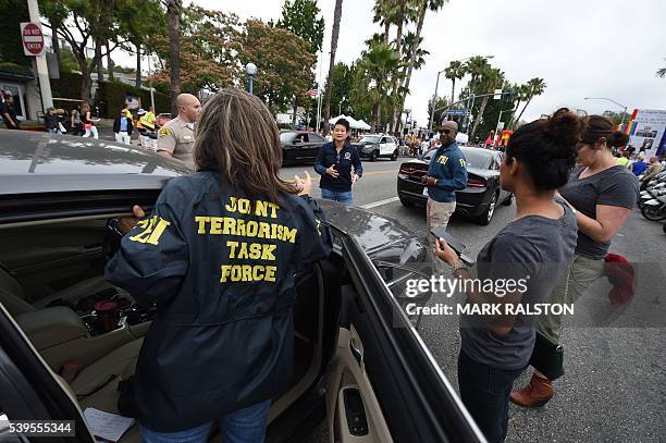 Members of the FBI Joint Terrorism task force stand by to provide security for the 2016 Gay Pride Parade June 12, 20116 in Los Angeles, California....