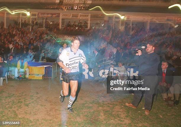 Andrew Ettingshausen leads the Cronulla Sharks onto the field for his 217th first grade game with the club. SHD Picture by JON REID