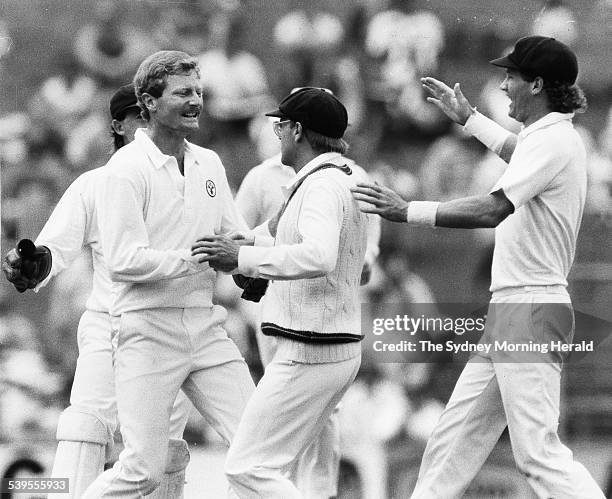 Peter Taylor shakes hands with Dirk Wellham after he caught David Gower off Taylor for 72, 17 January 1987. SMH Picture by STAFF