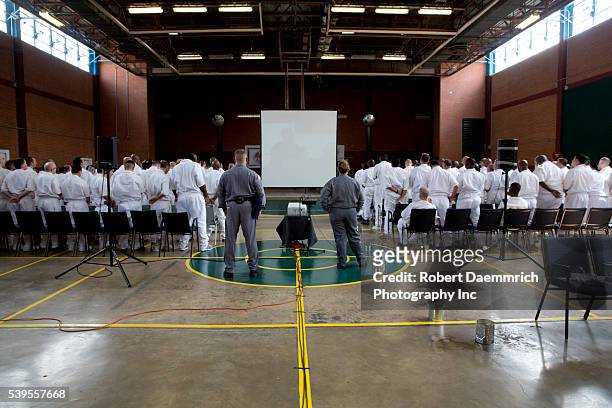 Male inmate students of a Christian ministry program inside a maximum security prison near Houston, Texas watch video feed of fellow prisoners during...