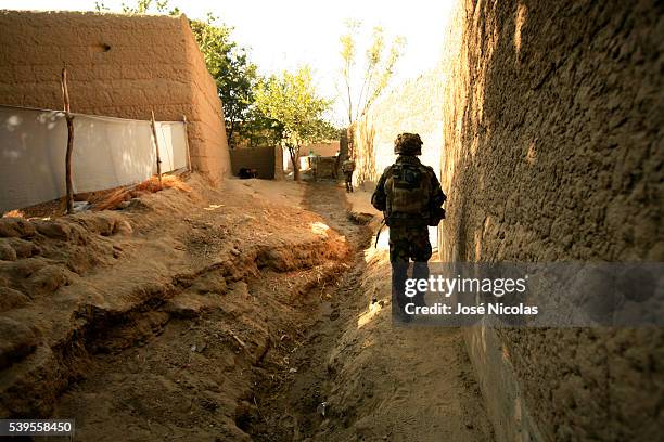 French paratroopers of the 8th Marine Infantry Parachute Regiment, the 8e Regiment Parachutiste d'Infanterie de Marine , search through a village in...