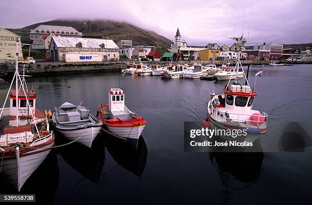 The harbor of Husavik. Husavík is a small town in the north of Iceland on the shores of Skjalfandi bay. Inhabitants derive their income from tourism...