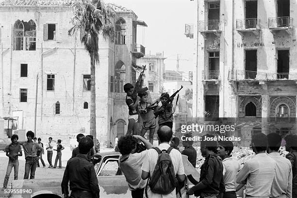 Lebanese children brandishing Kalashnikovs for the press, during the First Lebanon War.