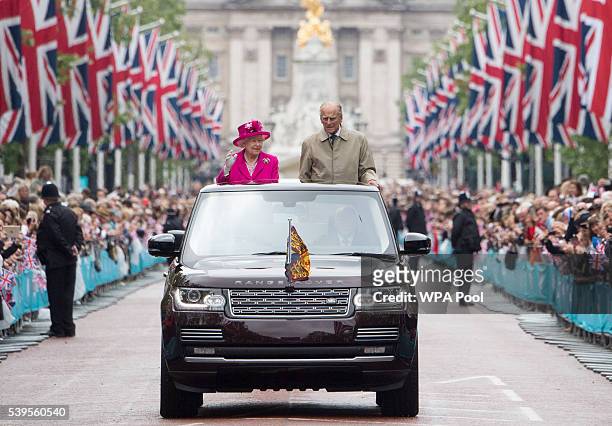 Queen Elizabeth II and Prince Philip, Duke of Edinburgh wave to guests attending "The Patron's Lunch" celebrations for The Queen's 90th birthday on...