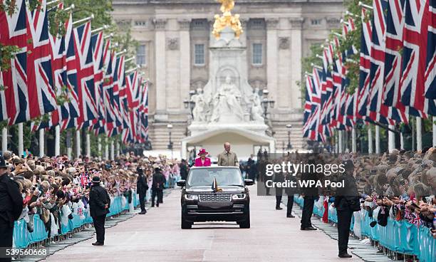 Queen Elizabeth II and Prince Philip, Duke of Edinburgh wave to guests attending "The Patron's Lunch" celebrations for The Queen's 90th birthday on...