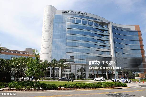 Police cars are seen outside of the Orlando Regional Medical Center, as friend and family gather to learn about loved ones who may have been victims...