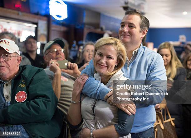 Republican presidential candidate Ted Cruz, r, and wife Heidi snuggle before the introductions as he continues courting voters with a bus tour of...