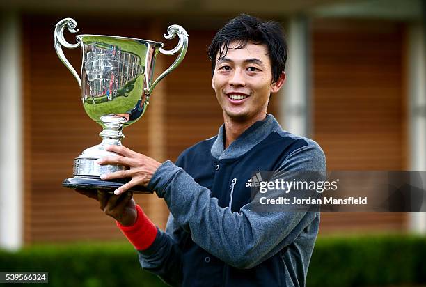 Yen-Hsun Lu of Taipei poses with the trophy after winning his Men's Final match against Marius Copil of Romania during day nine of the Aegon Surbiton...