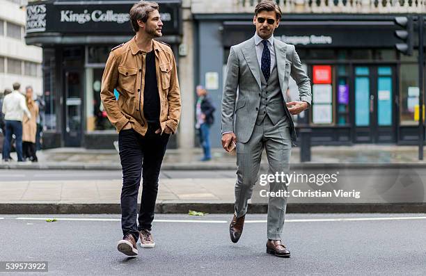 Model Johannes Huebl wearing a grey suit, vest and tie and Robert Konjic outside Christopher Raeburn during The London Collections Men SS17 on June...