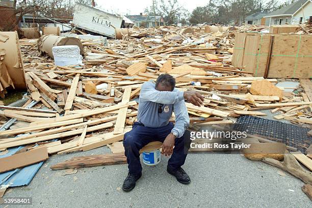 Firefighter Jerome Crenshaw wipes sweat away during a break from the recovery efforts in the aftermath of Hurricane Katrina September 1, 2005 in...