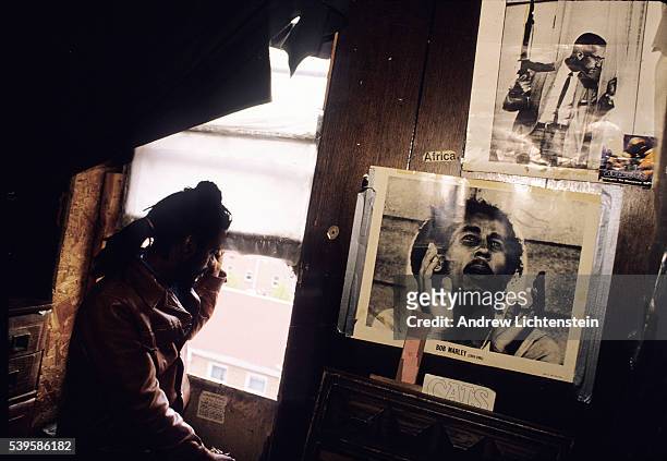 An East Village squatter watches the street from his bedroom for police activity, because the building he is living in has been ordered by city...