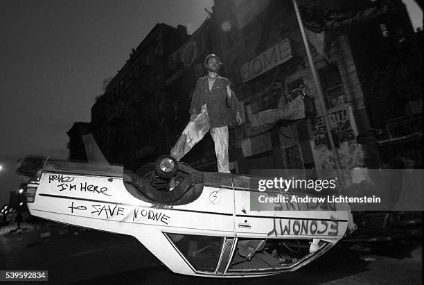 Squatters attempt to defend their building from an expected atttack by the police on East 13th Street by blocking the street with ovrturned cars and...