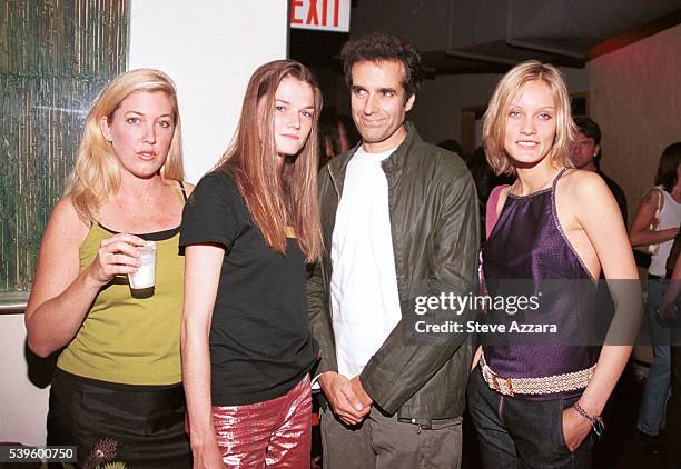 Magician/model recruiter David Copperfield with unidentified women.