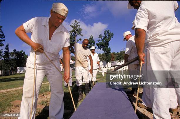 Prisoners on a burial crew bury a man executed by the State in Huntsville's prison cemetery. The state of Texas executes more people than all of the...