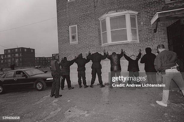 Special narcotics task force, formed by the police to combat the crack epidemic in Bridgeport, lines people up against a wall to search them in the...