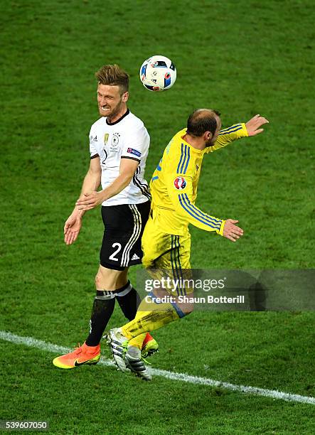 Shkodran Mustafi of Germany and Roman Zozulya of Ukraine compete for the ball during the UEFA EURO 2016 Group C match between Germany and Ukraine at...