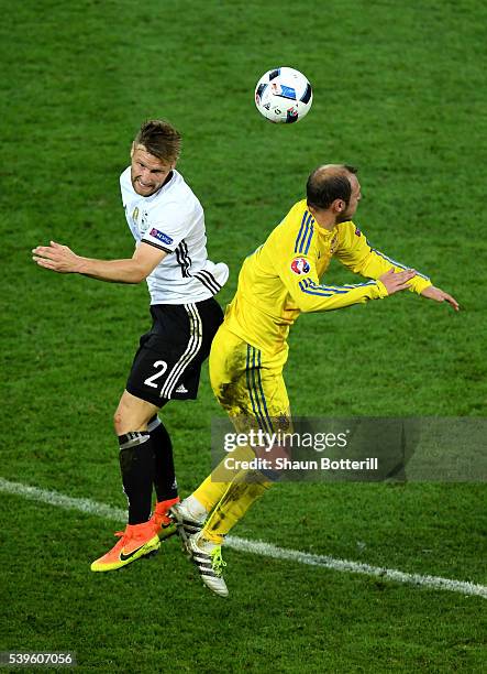 Shkodran Mustafi of Germany and Roman Zozulya of Ukraine compete for the ball during the UEFA EURO 2016 Group C match between Germany and Ukraine at...