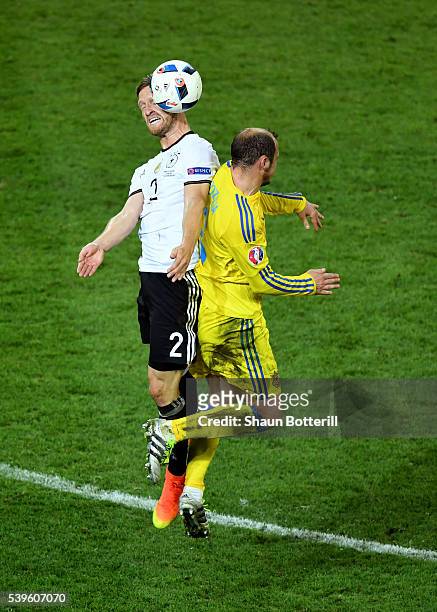 Shkodran Mustafi of Germany and Roman Zozulya of Ukraine compete for the ball during the UEFA EURO 2016 Group C match between Germany and Ukraine at...
