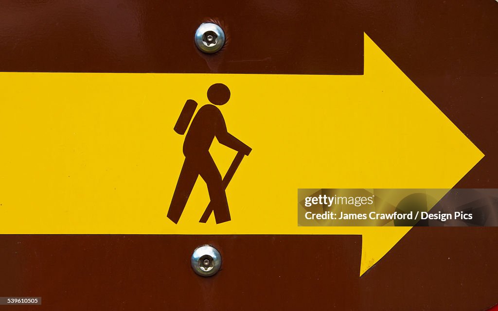 A Sign Points To A Hiking Trail
